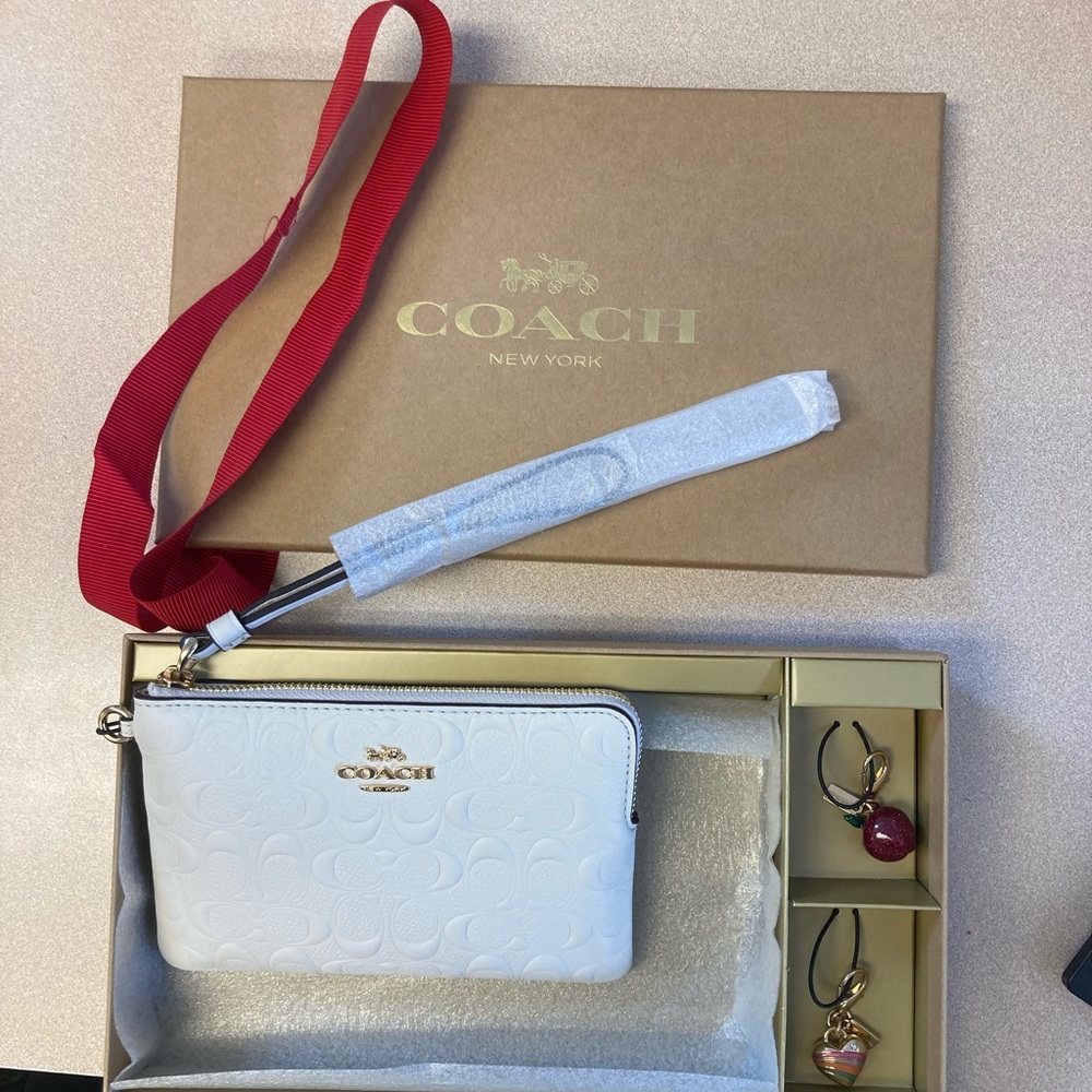 Coach off white wristlet with apple charm 🍎and heart charm.💛